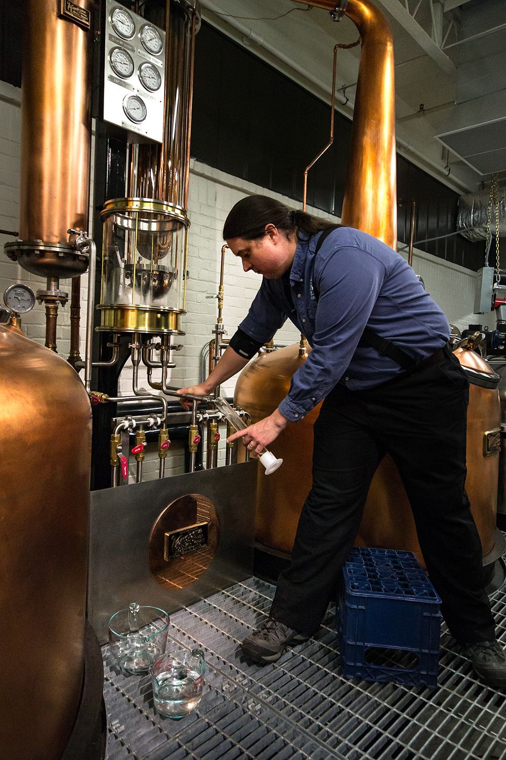 Employee Justin takes a sample during the distilling process.