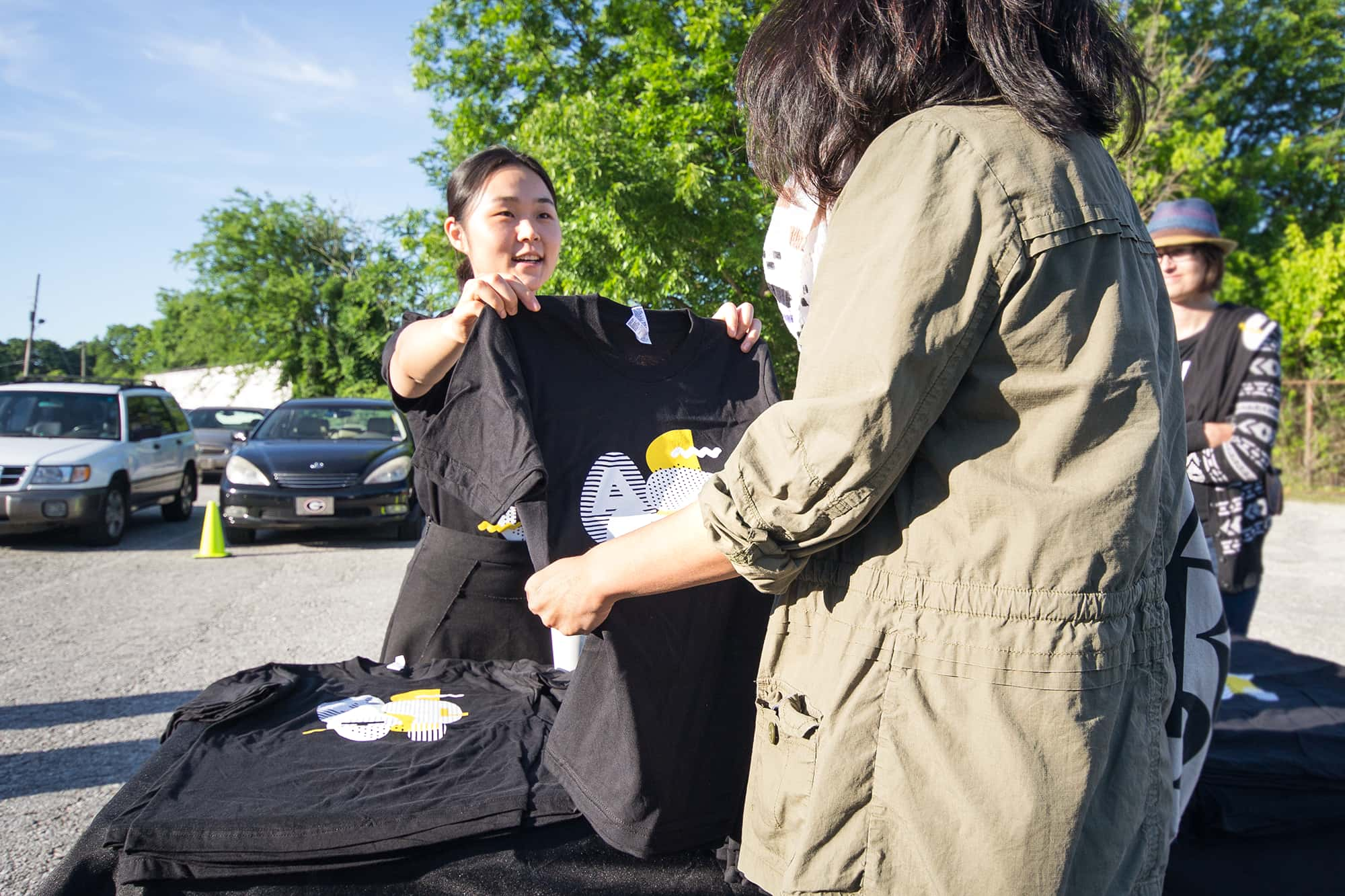 Handing out printed event t-shirts.