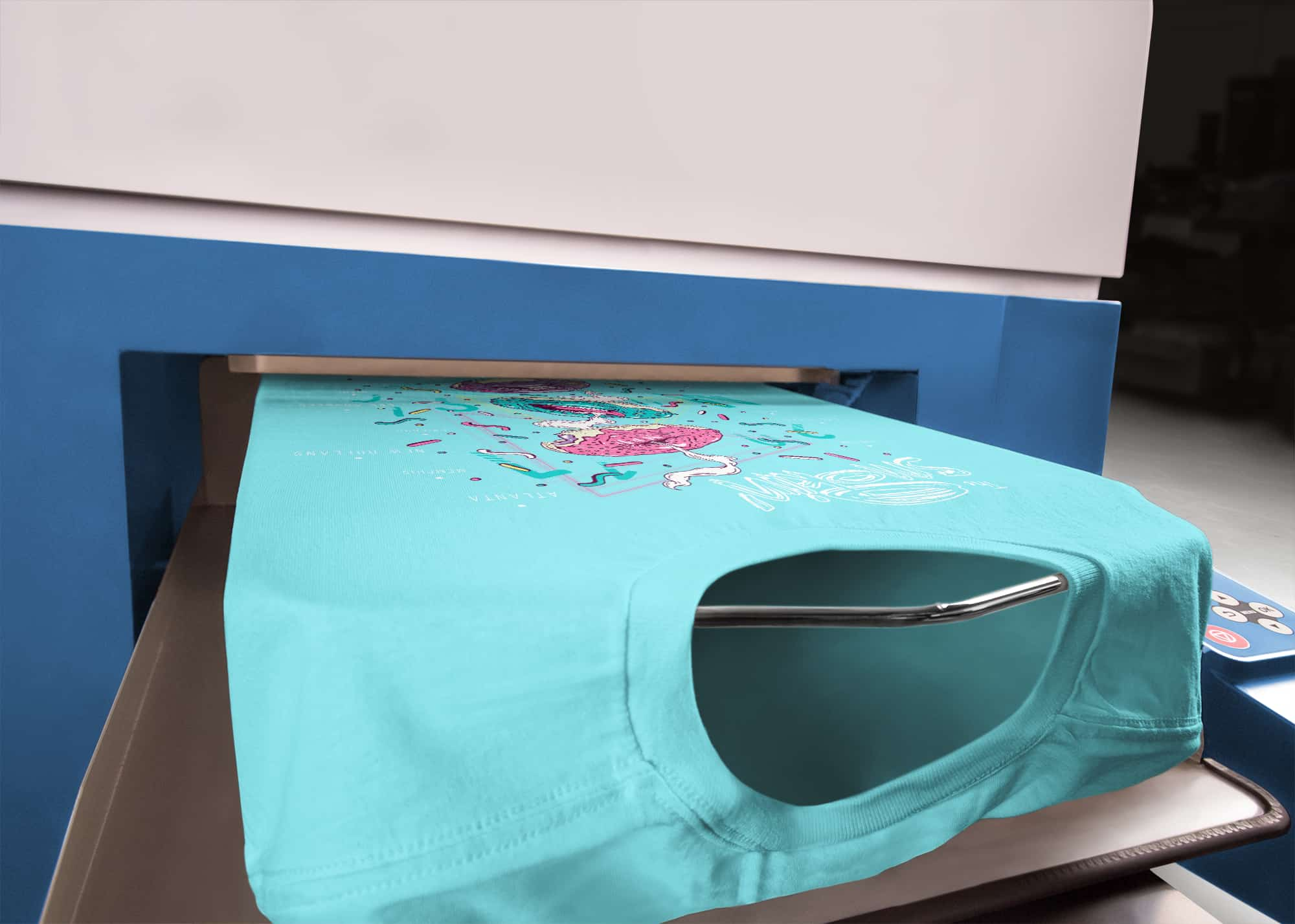 A detail shot of a t-shirt as it exits a direct-to-garment printer.