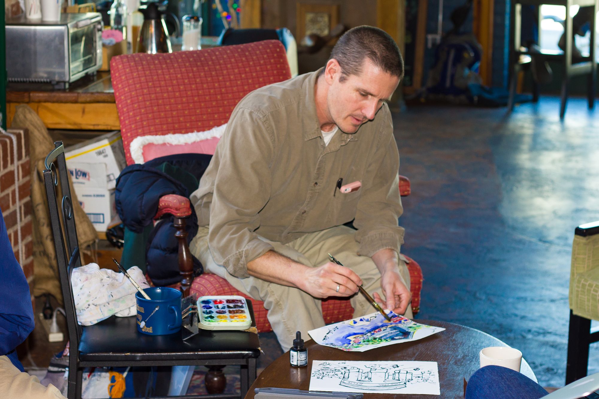 Artist Jamie Calkin as he works on a small painting.