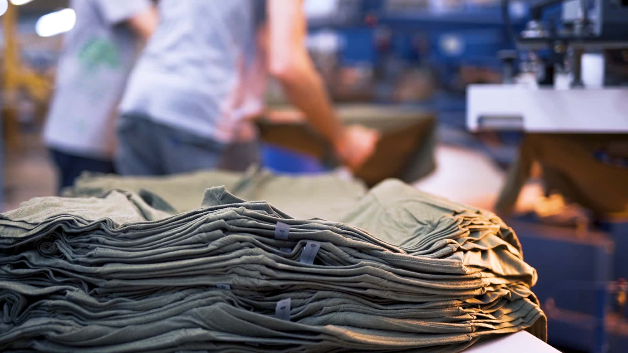 A t-shirt stack staged for printing.