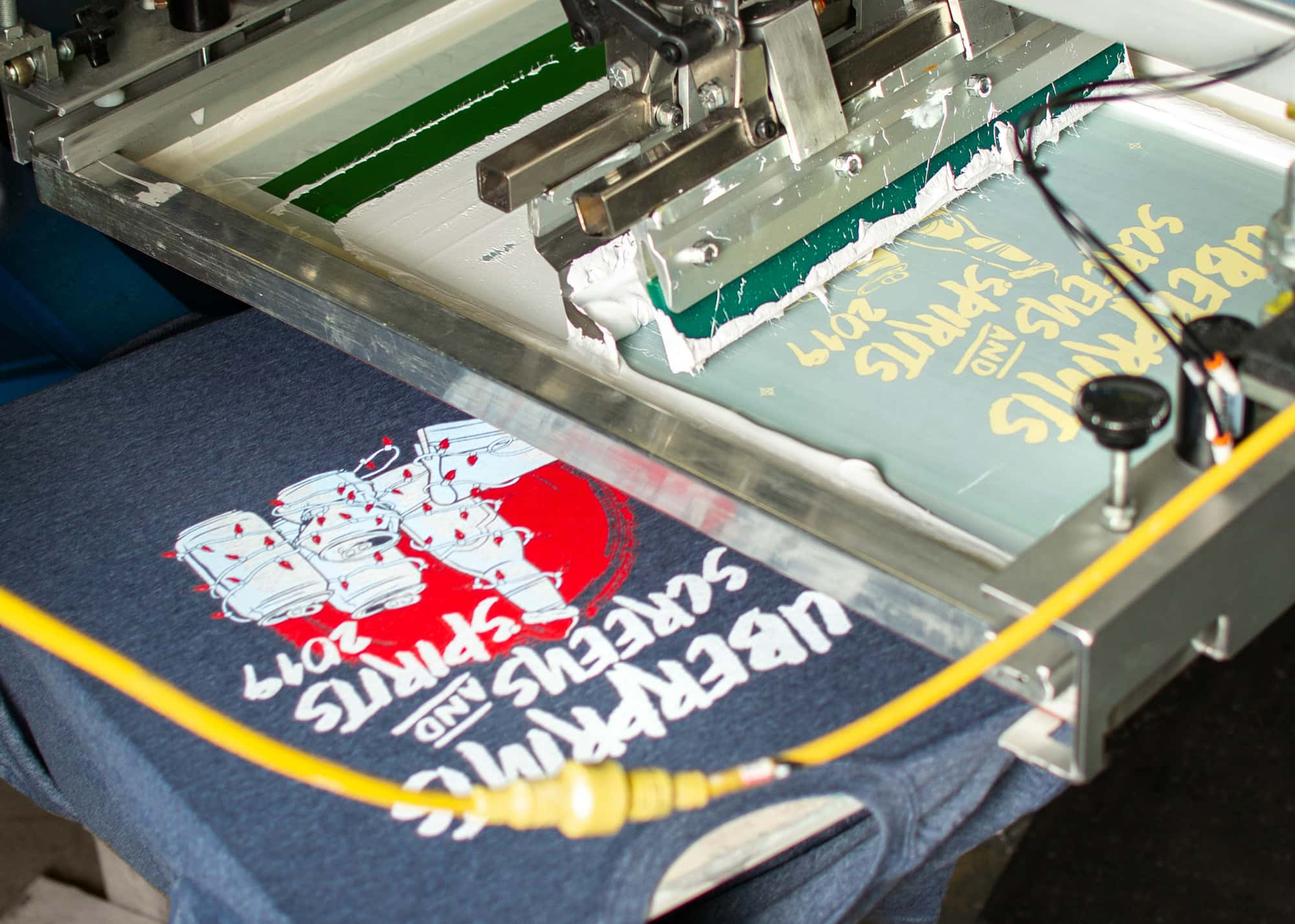 Displaying the printed Screens And Spirits design next to the press that printed it.