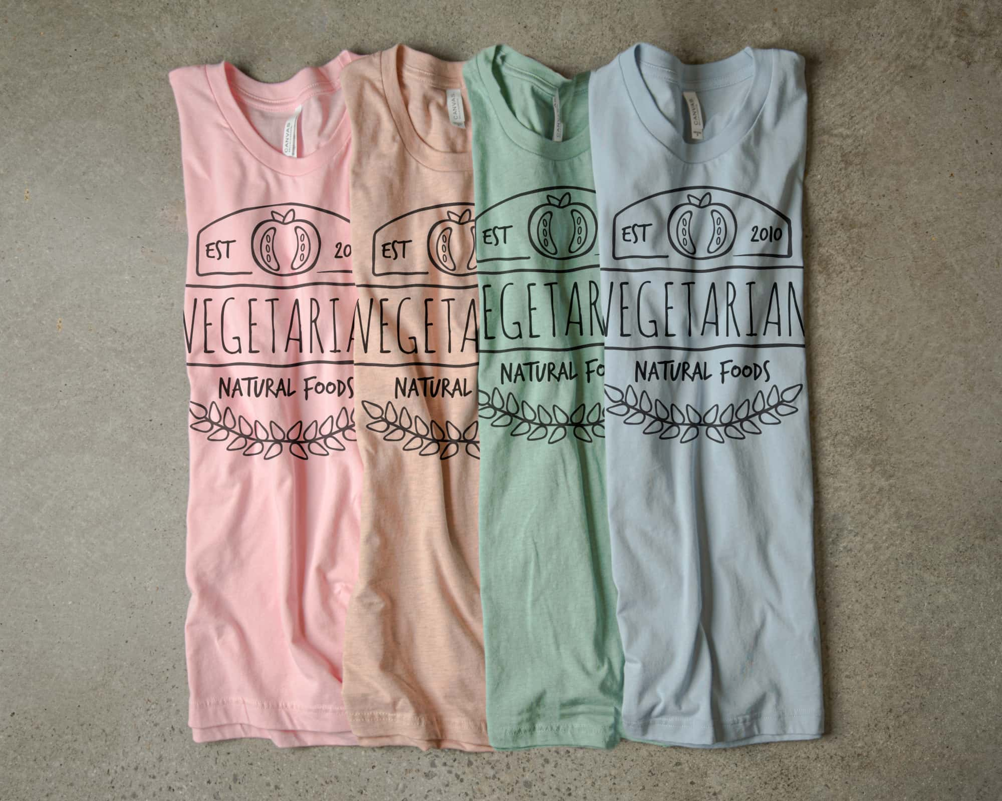 Our pastel color pallet shown in various t-shirt colors with a monochromatic design.