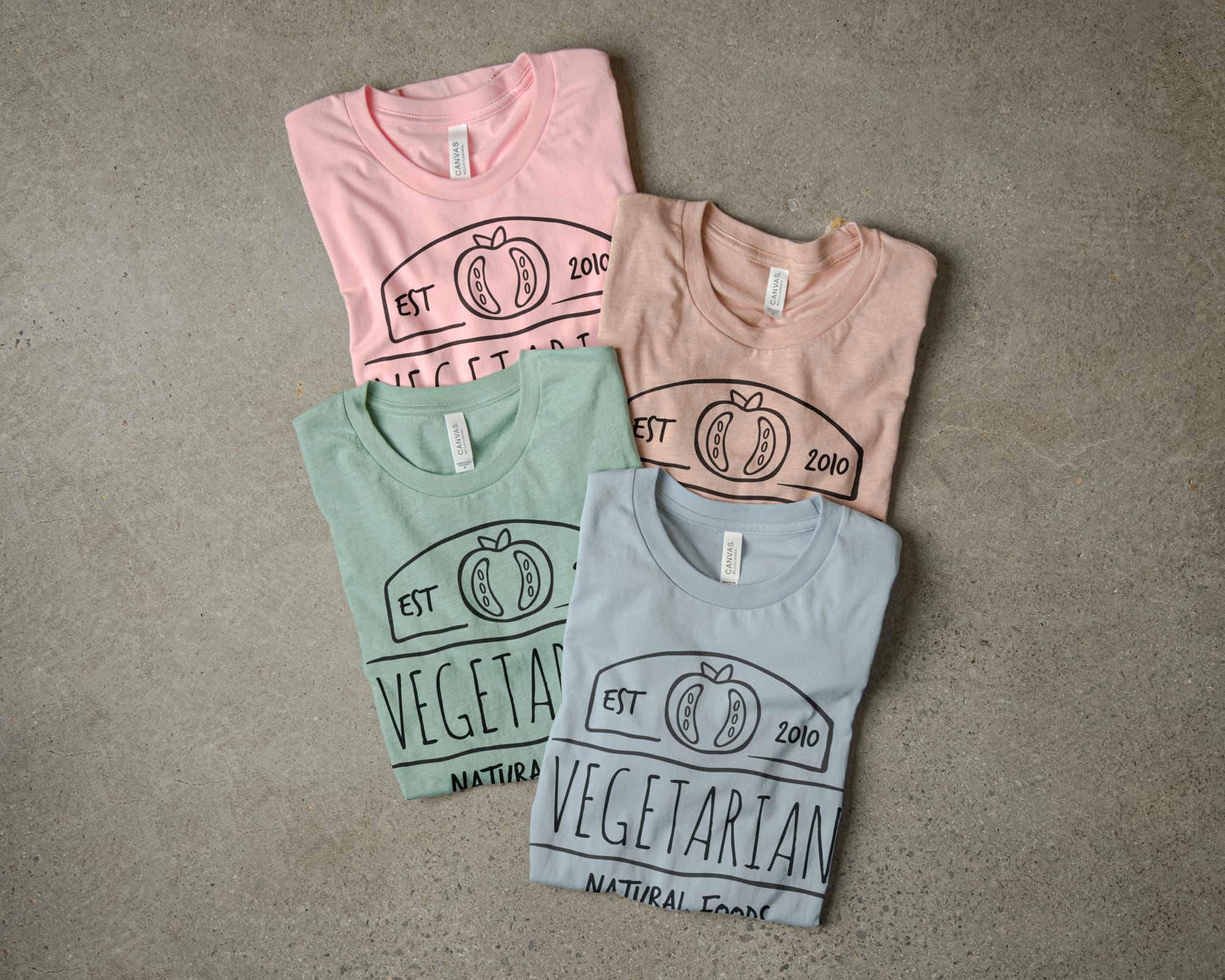 Folded t-shirt display arranged to exemplify the pastel pallet.