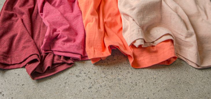 A detail image of various t-shirt colors that mimic the strawberries and cream color scheme.