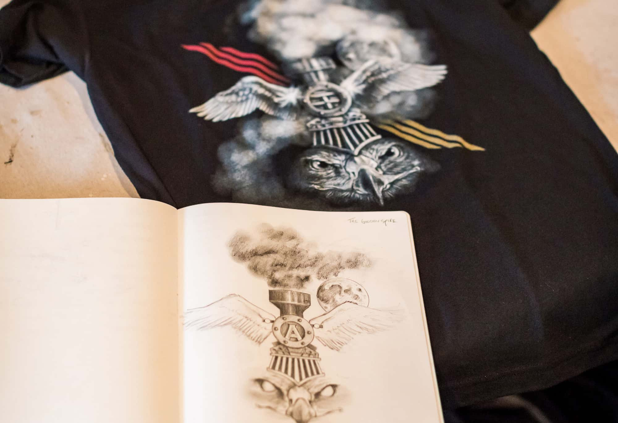 A detail image of Thomas Turner's notebook and printed t-shirt.