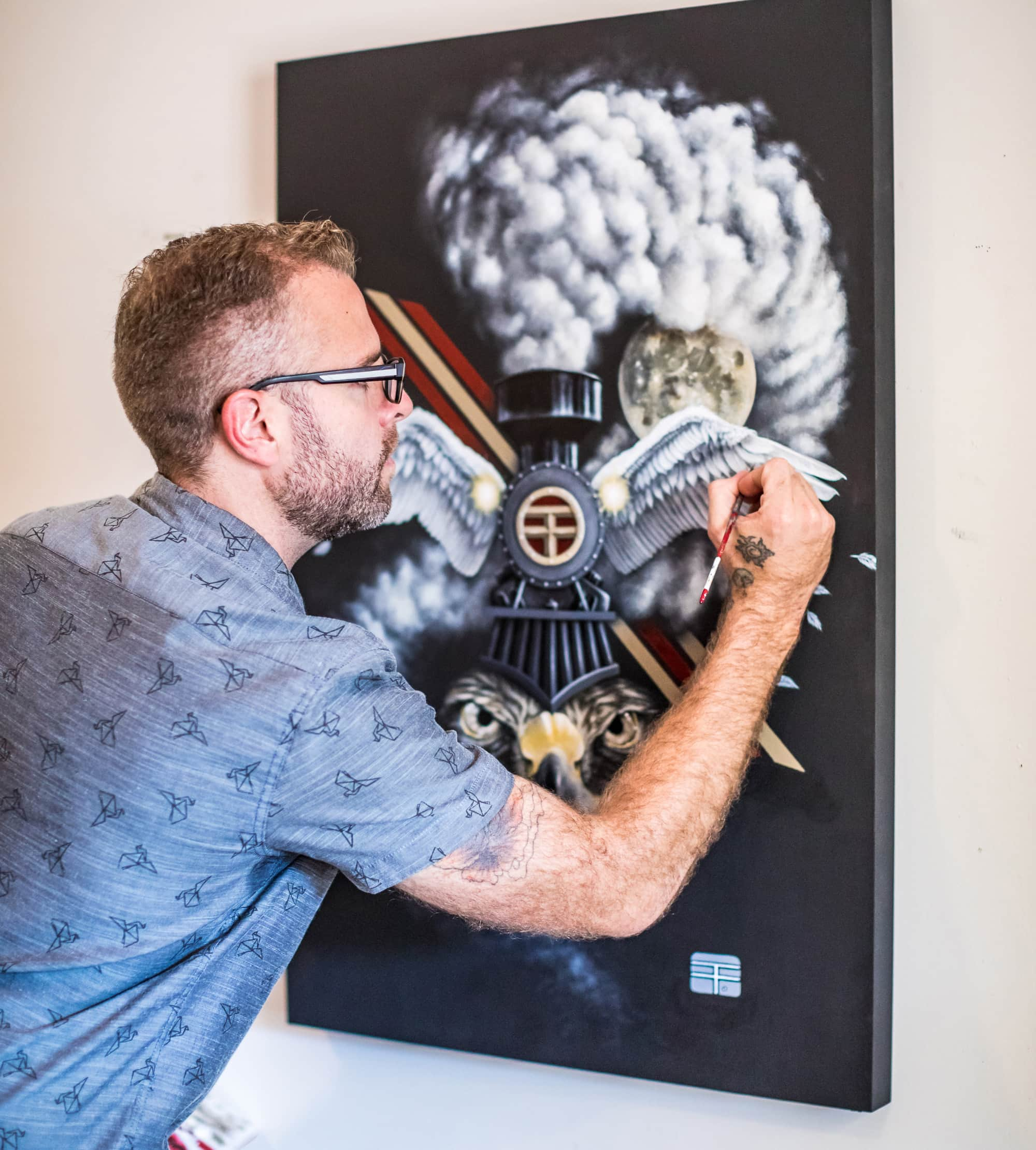 Artist Thomas Turner painting the work that was inspiration for his printed t-shirt.