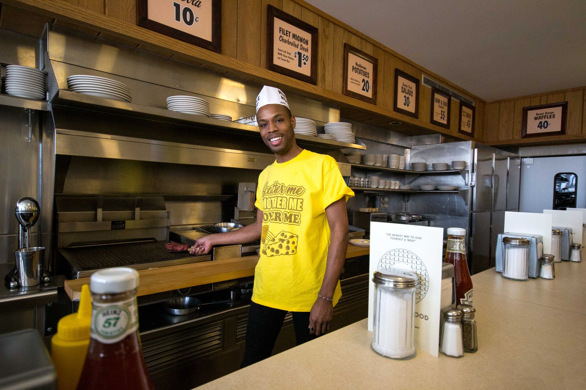 Tommy posing behind the Waffle House counter.