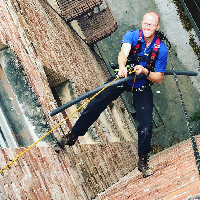 A researcher scaling a brick wall.