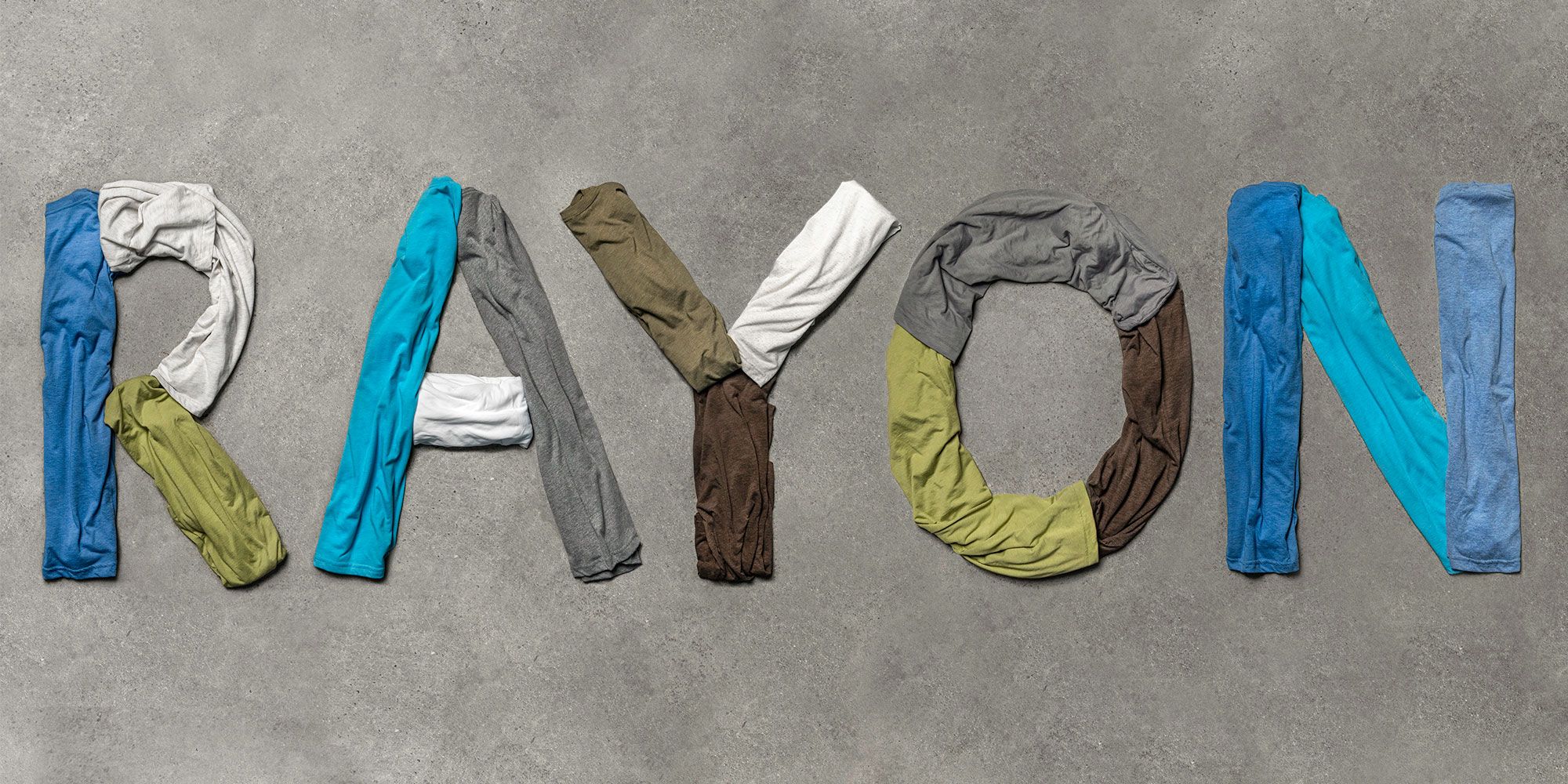 Flatlay image of t-shirts spelling out Rayon.