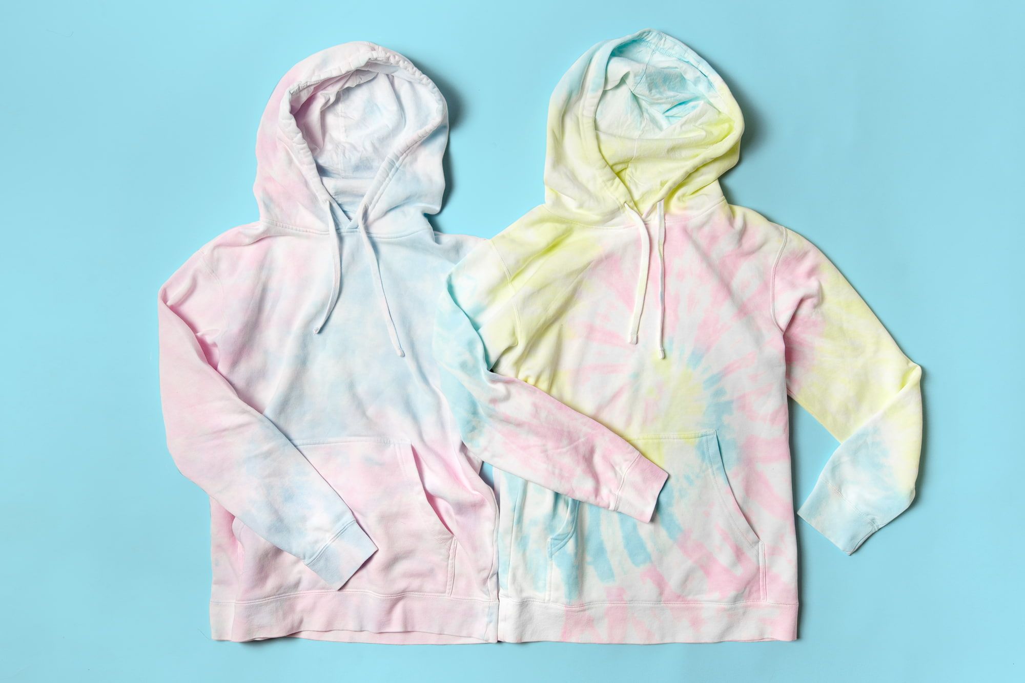 Flatlay image of two tie-dyed hoodies.