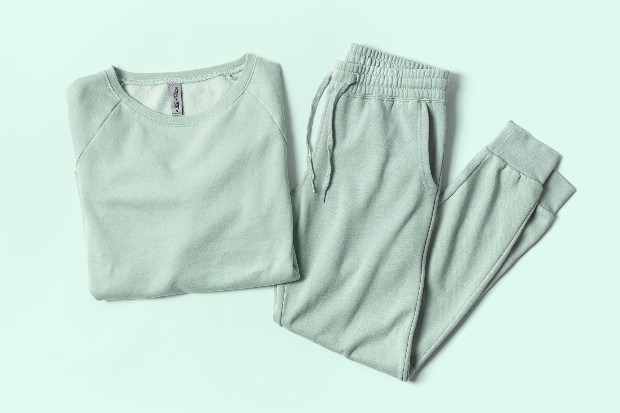 Flatlay image of garment washed fleece sweatpants and sweatshirt.