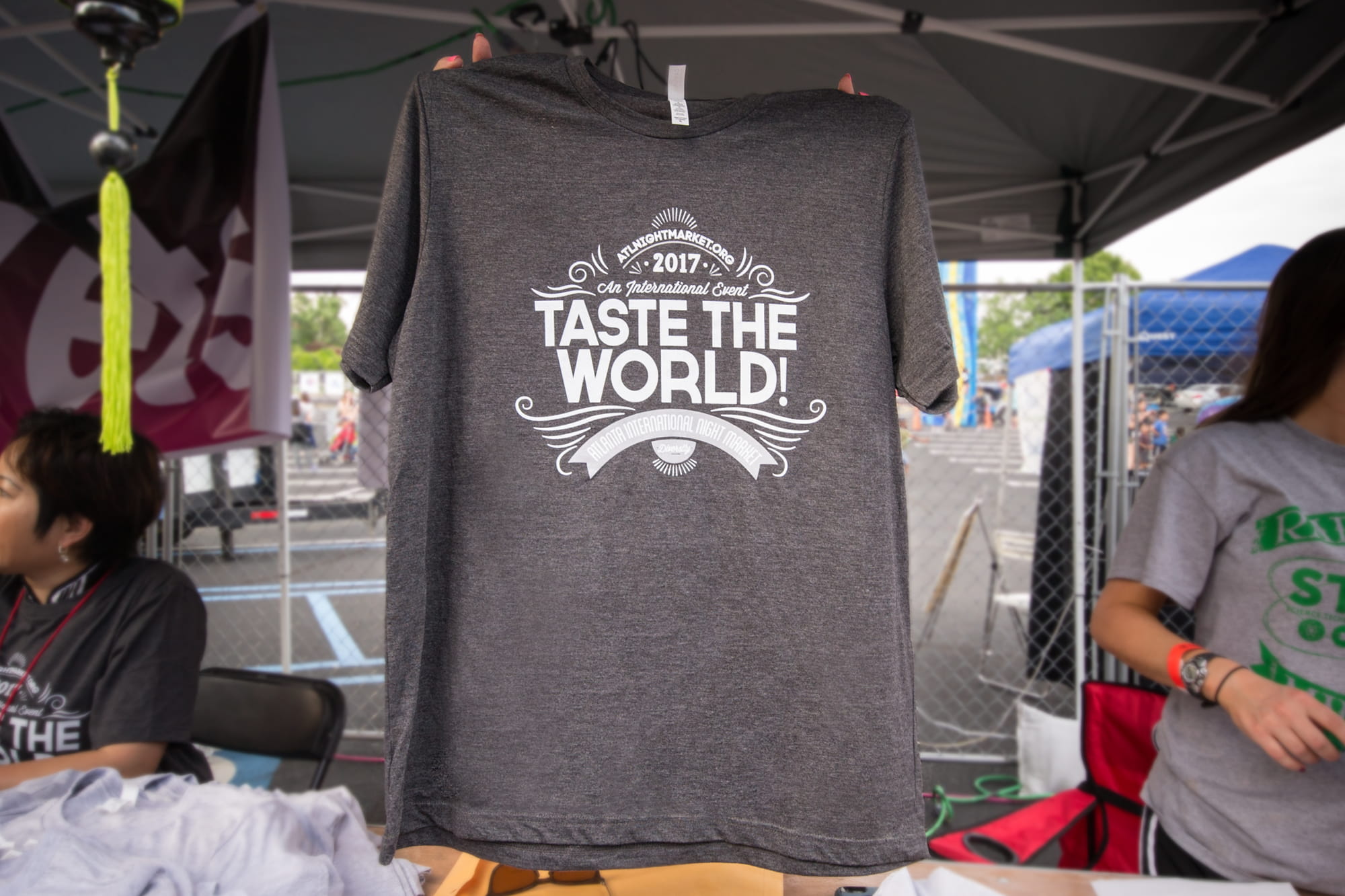 Photo of a custom event t-shirt being held up at a food festival.