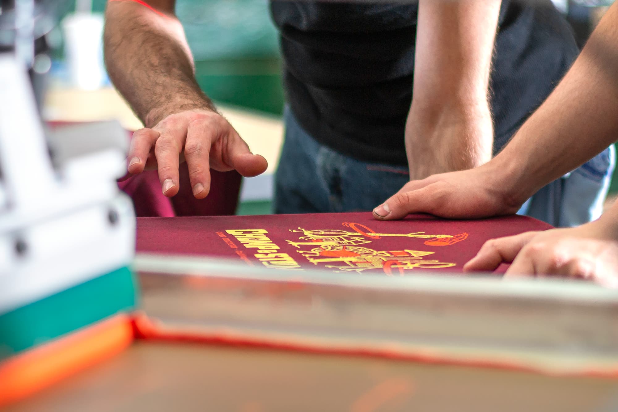 Image showing a behind the scenes look of our screen printers checking the accuracy of a customers order.