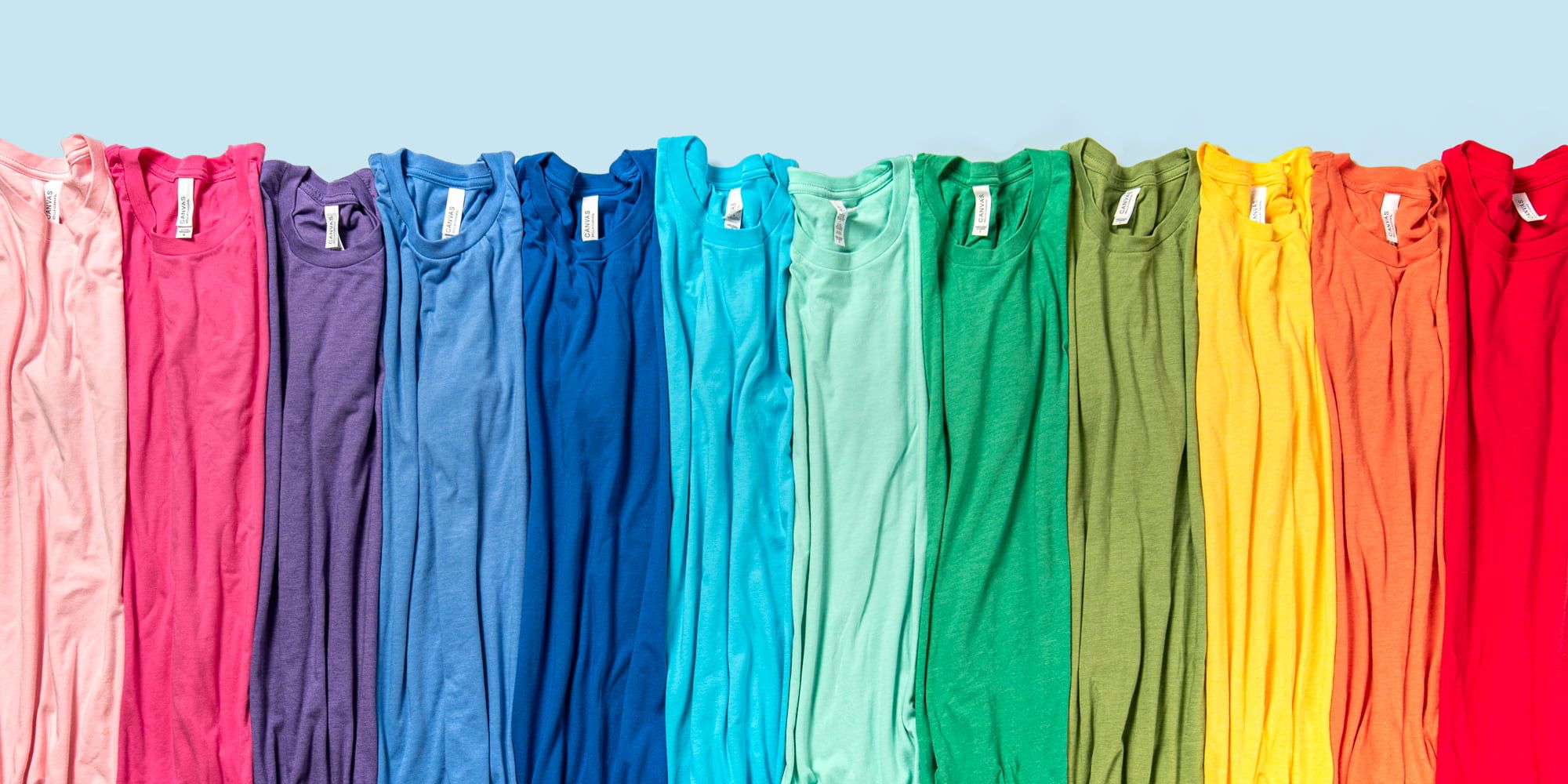 A line of rainbow colored Bella Canvas Jersey T-Shirts.