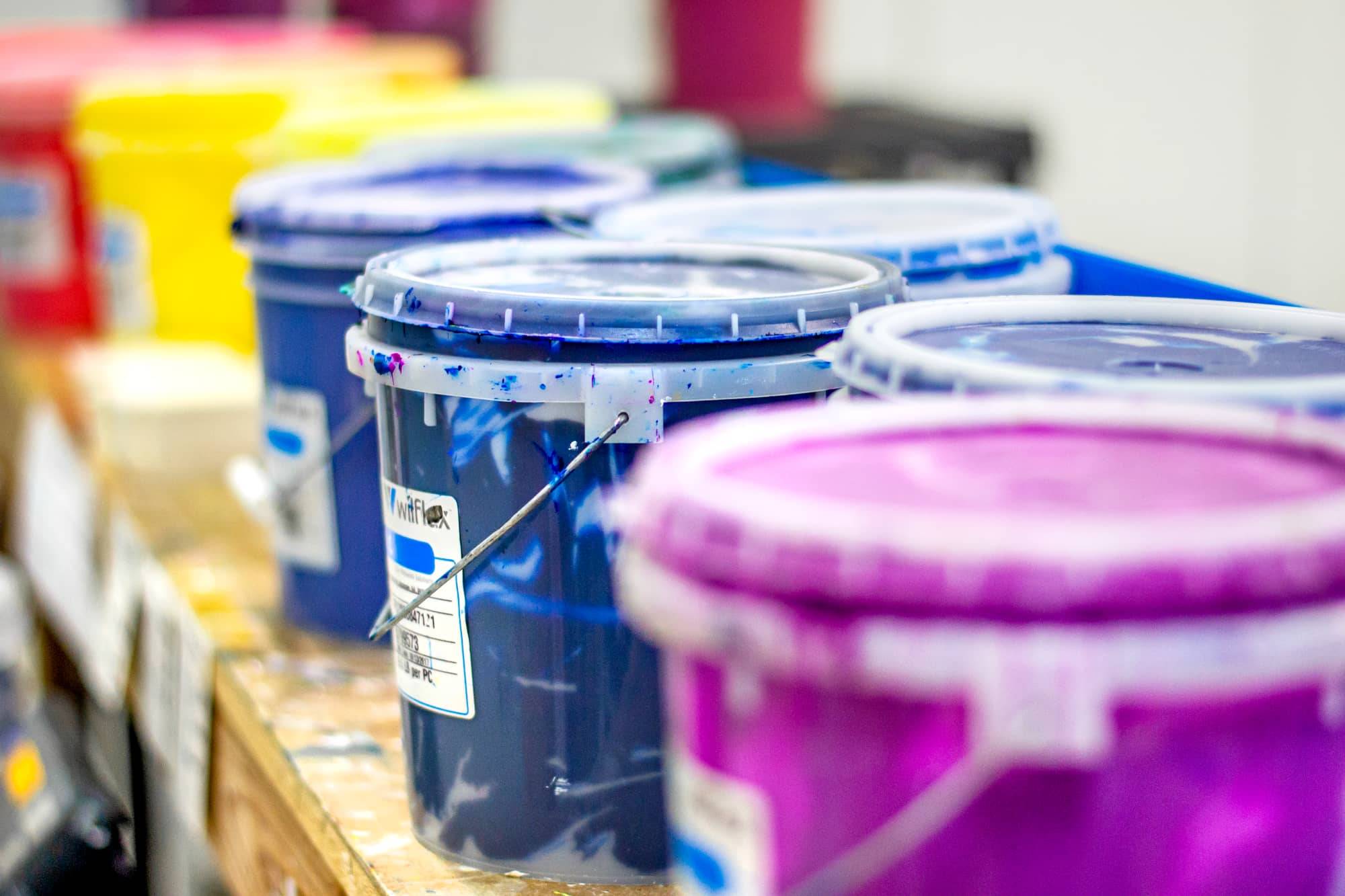 Buckets of screen printing ink in the UberPrints printing facility.