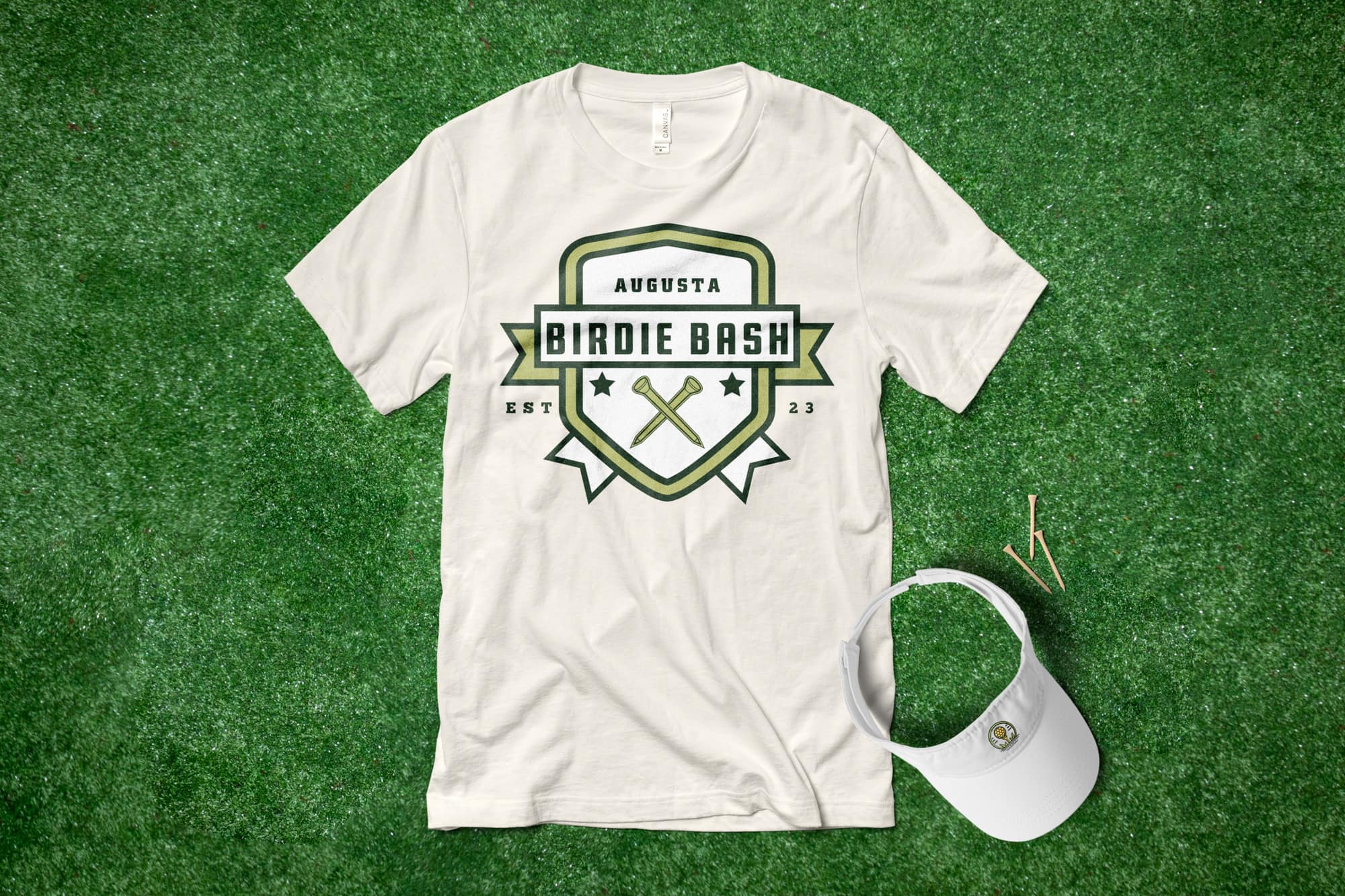 Flatlay on grass of a custom golf t-shirt with a simple banner design