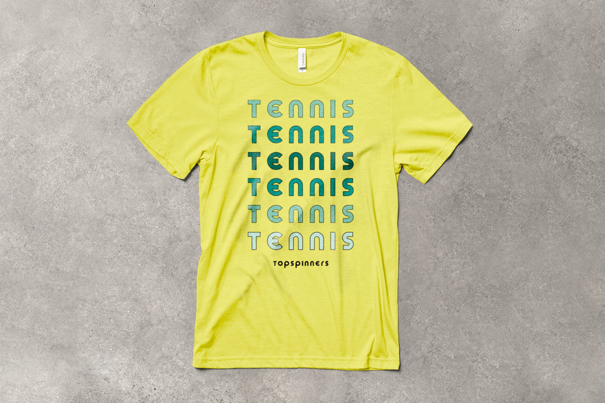 flatlay of a brightly colored t-shirt with a bold design that has the word "Tennis" repeating vertically