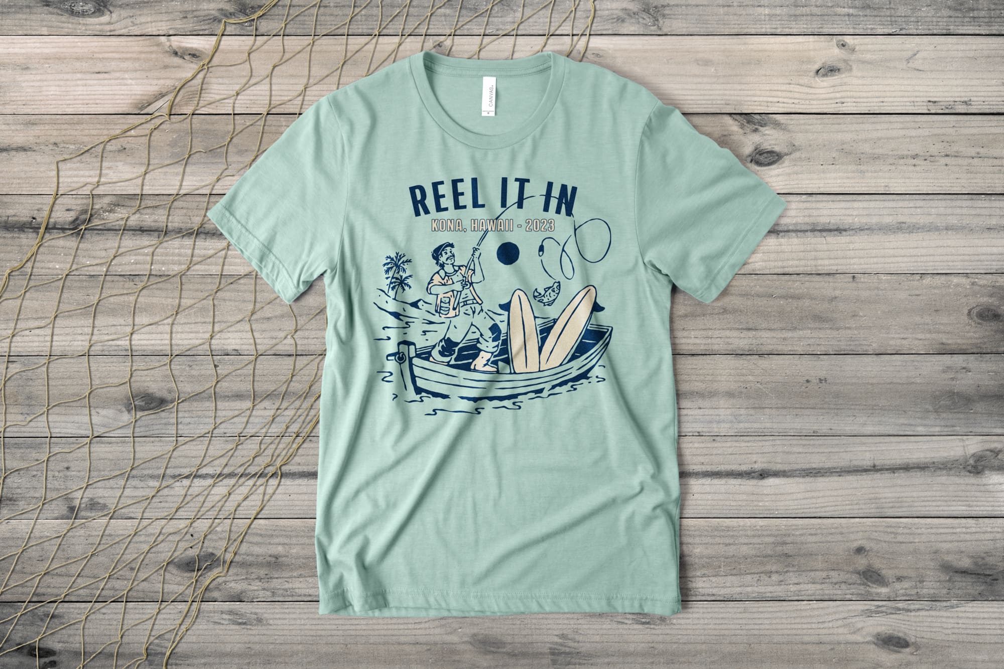 Custom t-shirt with a fishing themed template on the shirt. It says "Reel it In. Kona, Hawaii 2023"