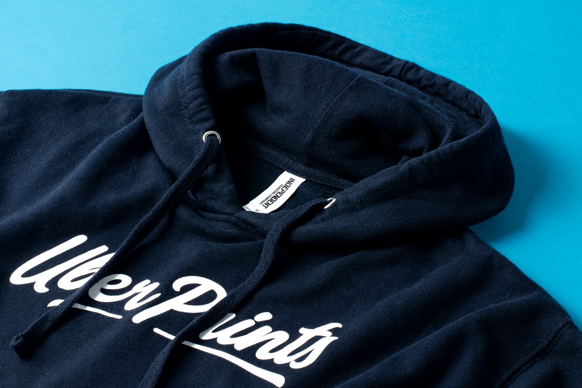 Detail view of the Premium Hoodie's collar and tag to show material