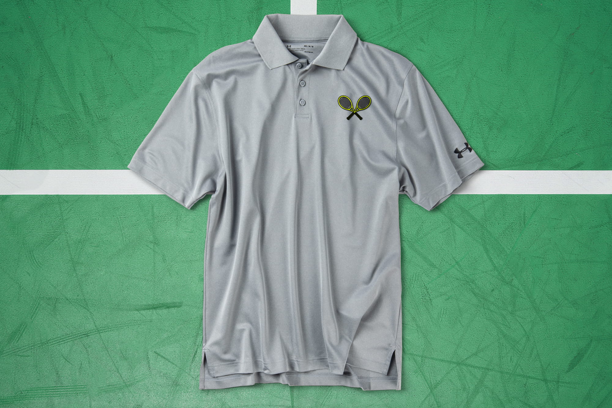 Flatlay of a premium polo with an embroidered tennis racket design on the left chest.