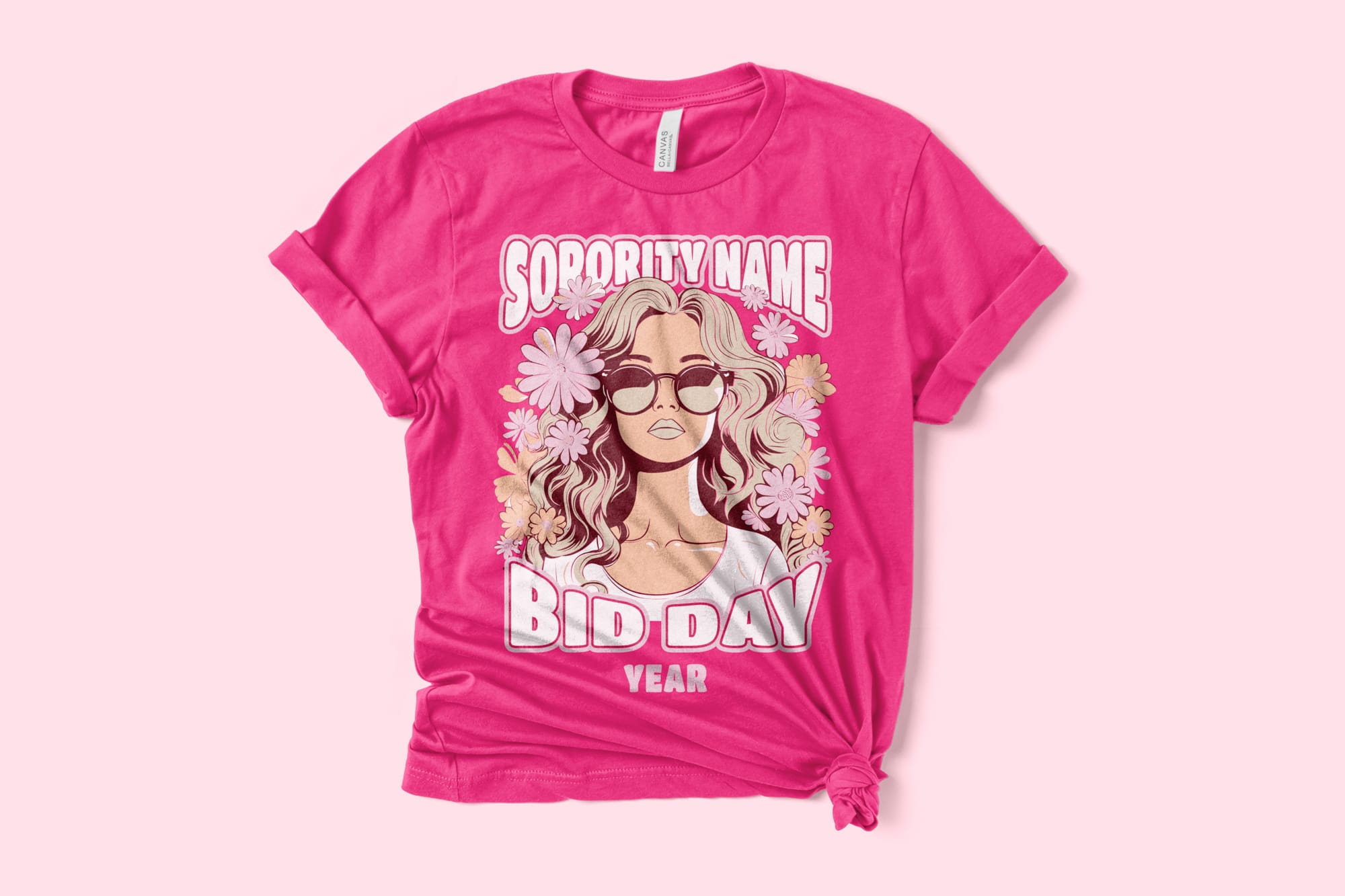 A bright pink shirt that has a barbie inspired design of a girl surrounded by flowers and bold text.