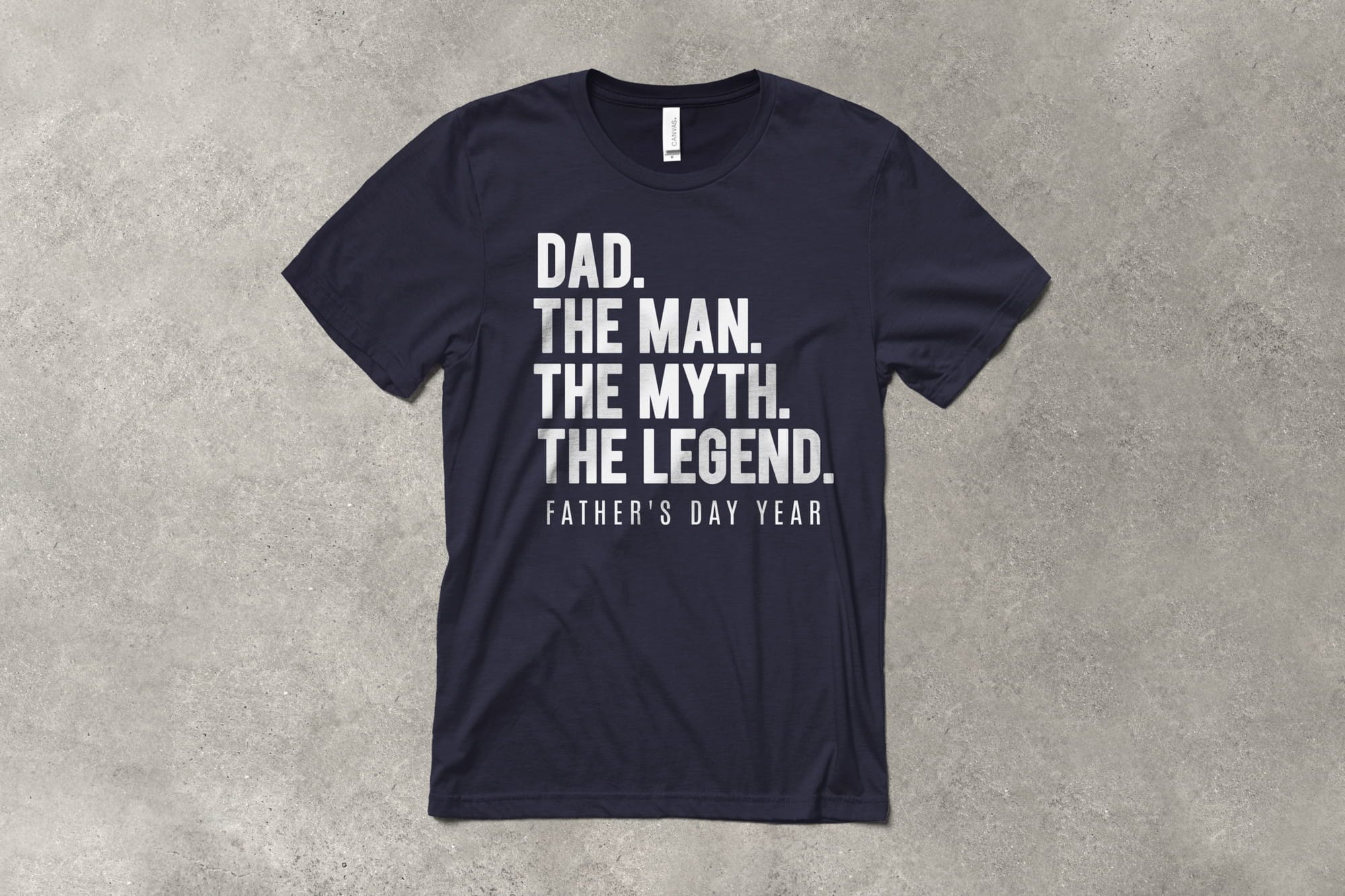 A flat t-shirt that has a customizable design that says "Dad. The man. The myth. The Legend."