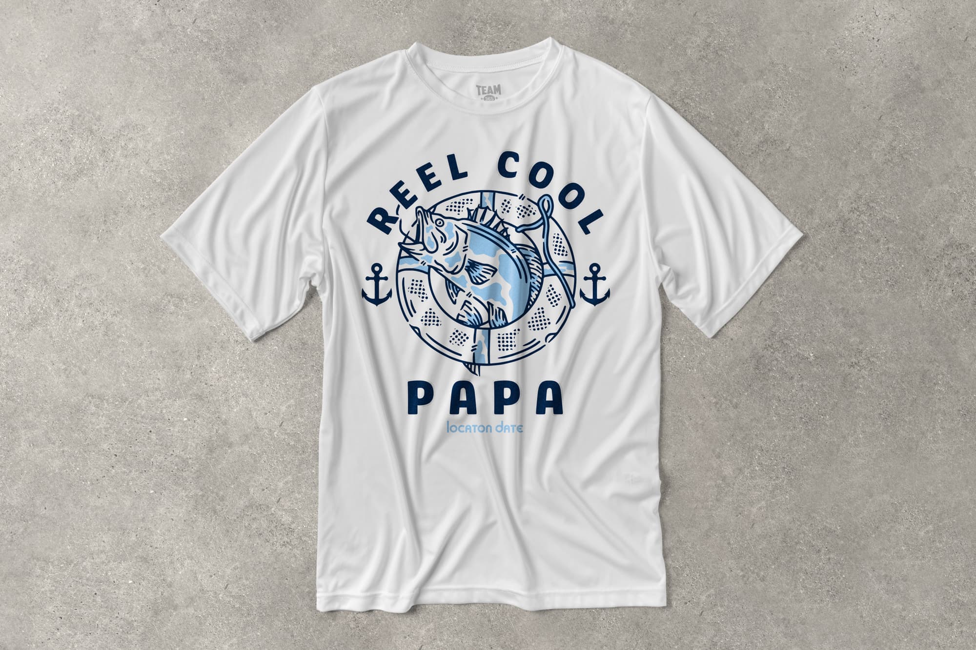 A flat performance t-shirt that has a customizable design that says "Reel cool Papa" and features a fish design