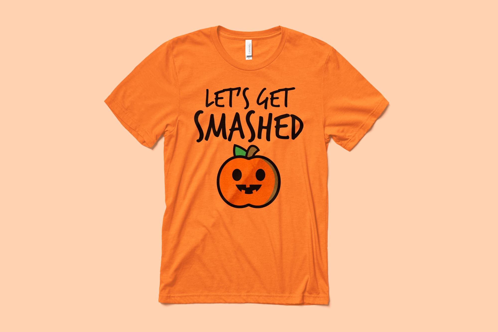 Image of an orange t-shirt with a customizable halloween design of a funny pumpkin.