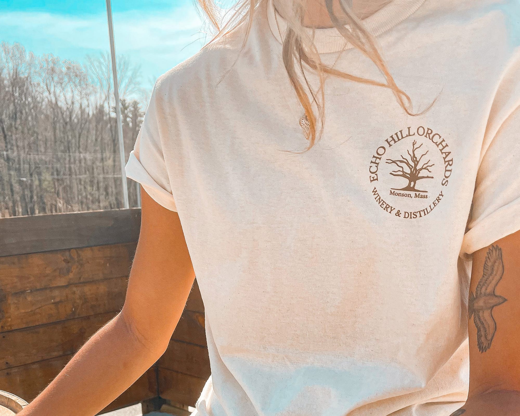 Image is of an employee of Echo Hill Orchards wearing a t-shirt with their company logo on it.