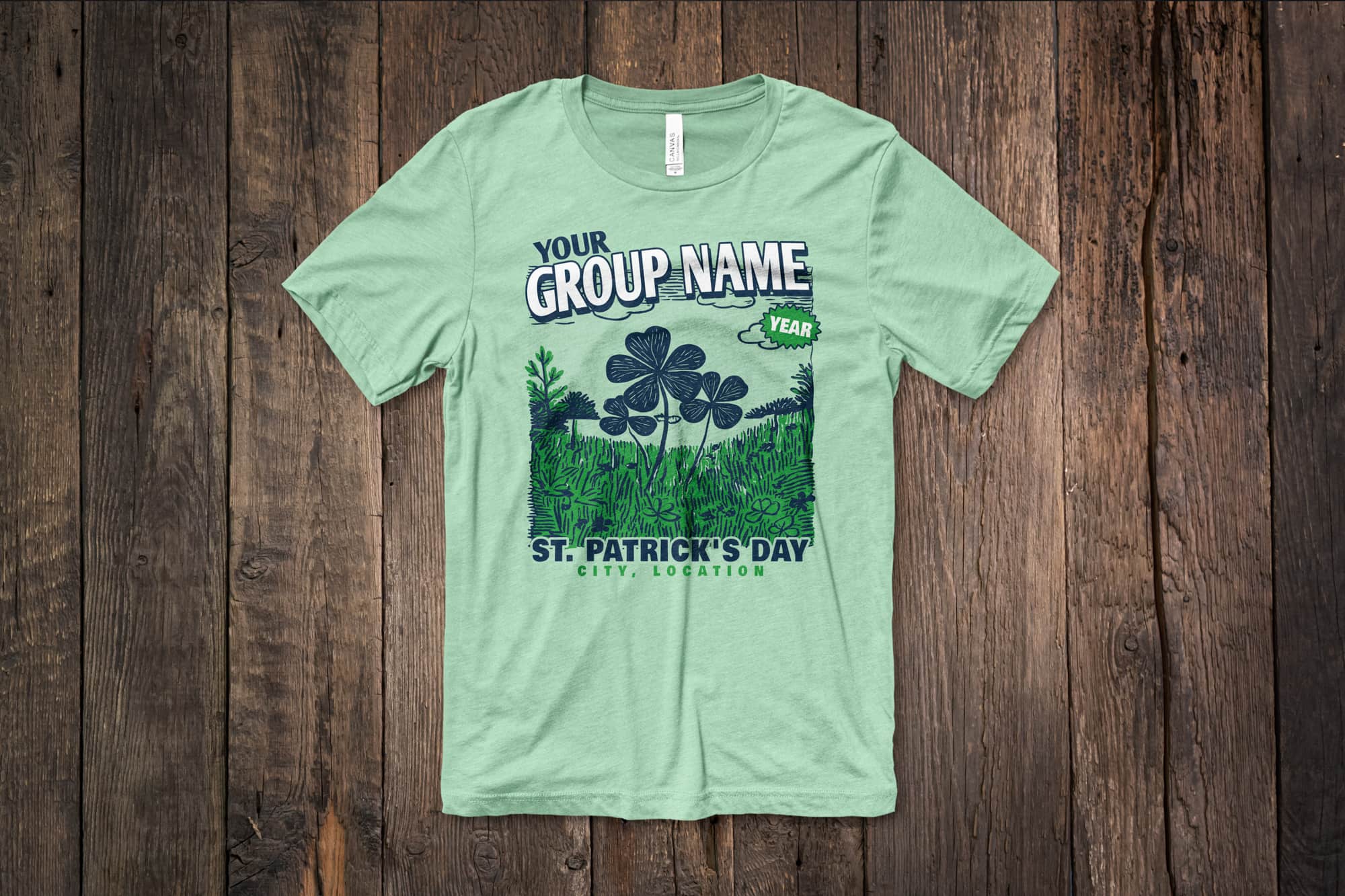 image of a flat green shirt with a customizable st. Patrick day design that shows shamrocks in a field