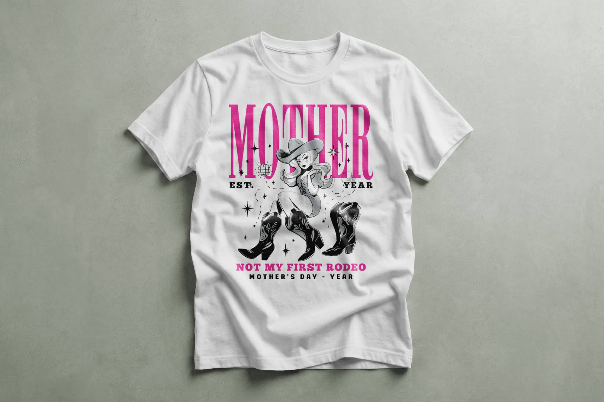 White T-shirt featuring a graphic of a woman in a cowboy hat, pink boots, and a lasso. Text: "Mother, Not My First Rodeo, Mother's Day."