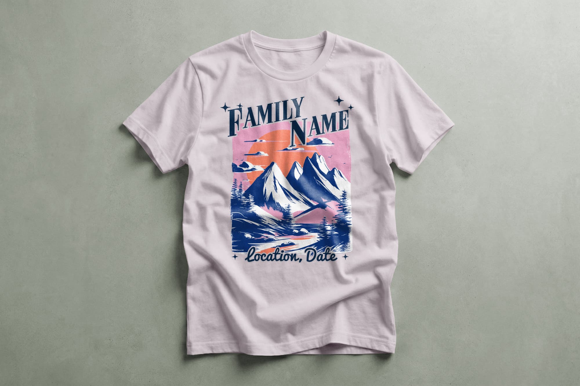 White T-shirt featuring a vintage-style illustration of snow-capped mountains against a pink sunset, with customizable text areas for family name, location, and date.